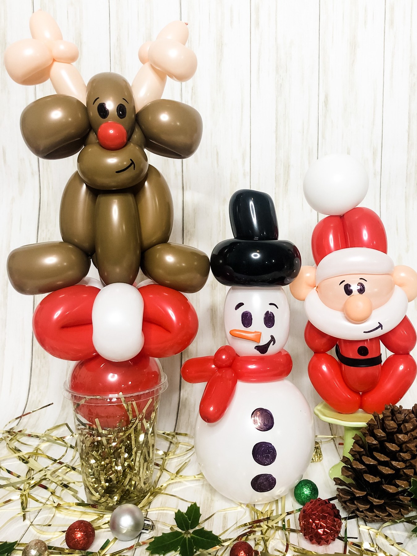 Holiday balloon sculptures by Whimsy Entertainment featuring a reindeer, snowman and Santa Claus.