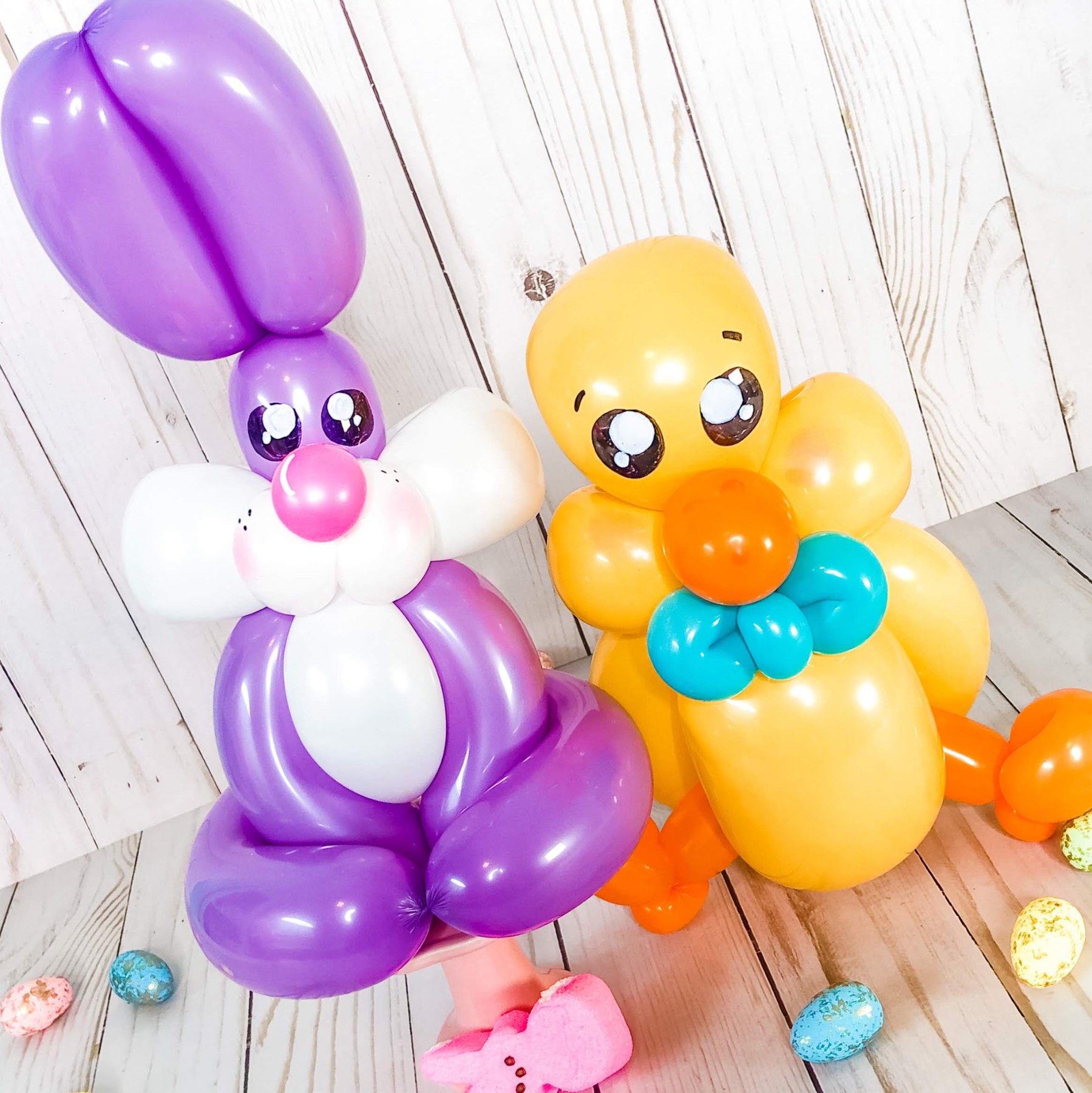 Easter balloon sculptures by Whimsy Entertainment featuring a purple bunny and yellow chick.