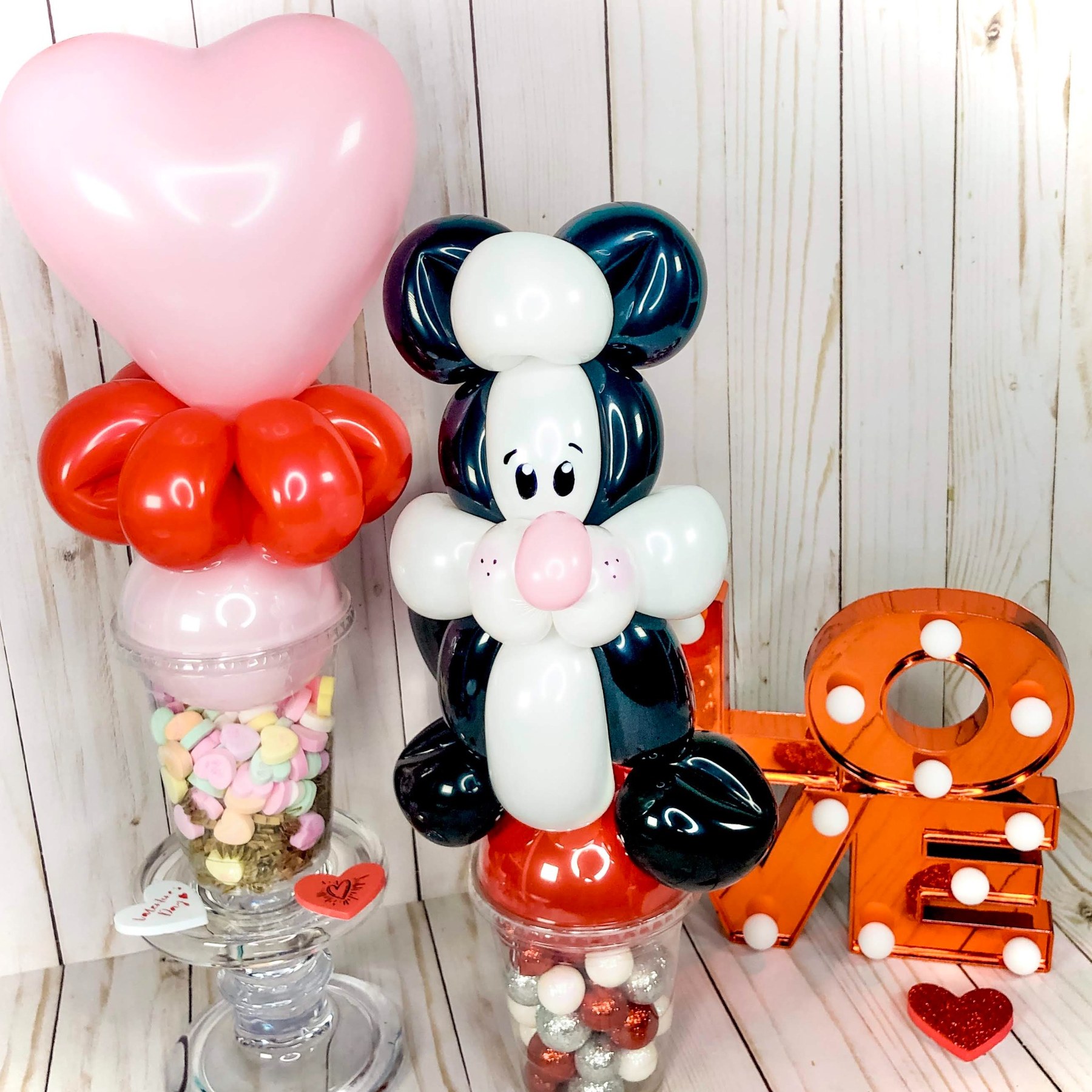 Valentine balloon gift display by Whimsy Entertainment with a balloon bunny, heart and candy-filled treat holder.