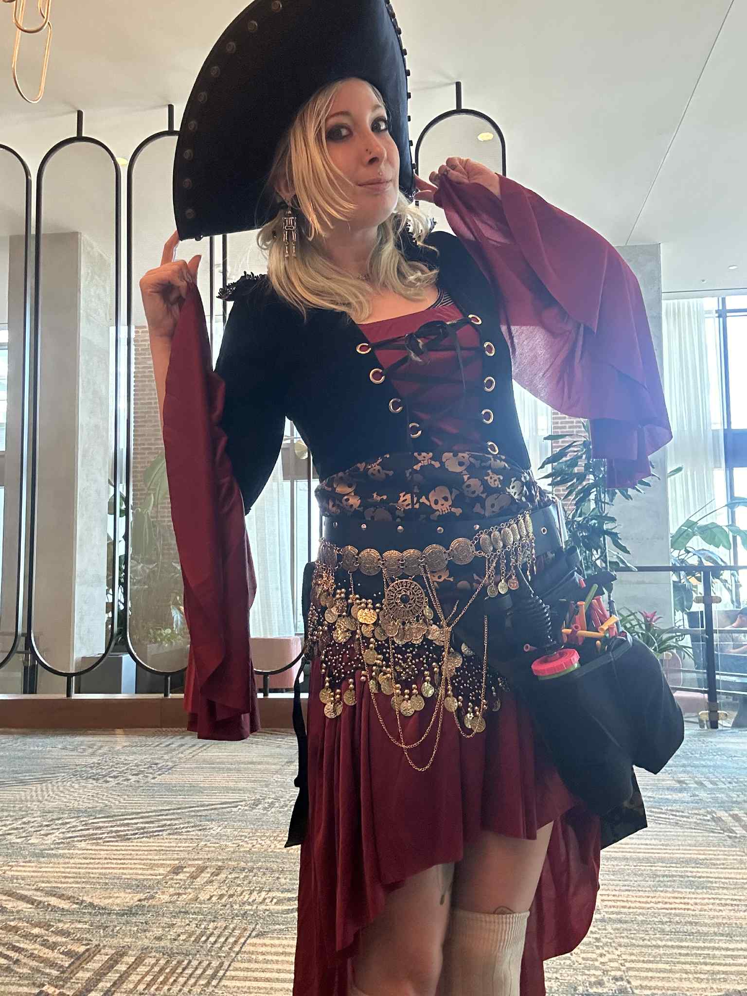 Balloon twisting party entertainment in Virginia Beach as Saria “Blu” Braska creates swords, animals and wearable balloon art for children and adults at a lively backyard celebration.