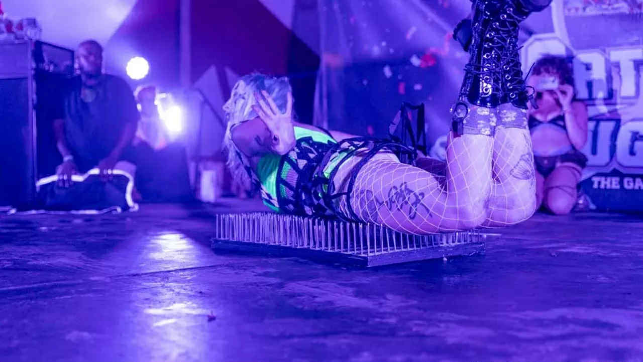 Fire eating and fire breathing performance by Whimsy Entertainment for a special event, blending circus clown character work with dramatic flame effects suitable for festivals and nightlife audiences.