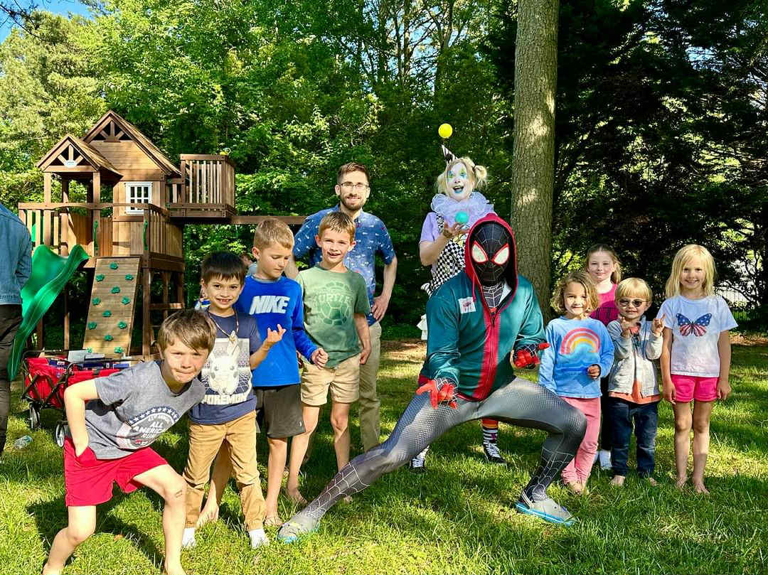 Roaming circus entertainer providing juggling, miming, giant bubbles and balloon animals for a community fair in Virginia, creating constant motion and fun for families and kids.